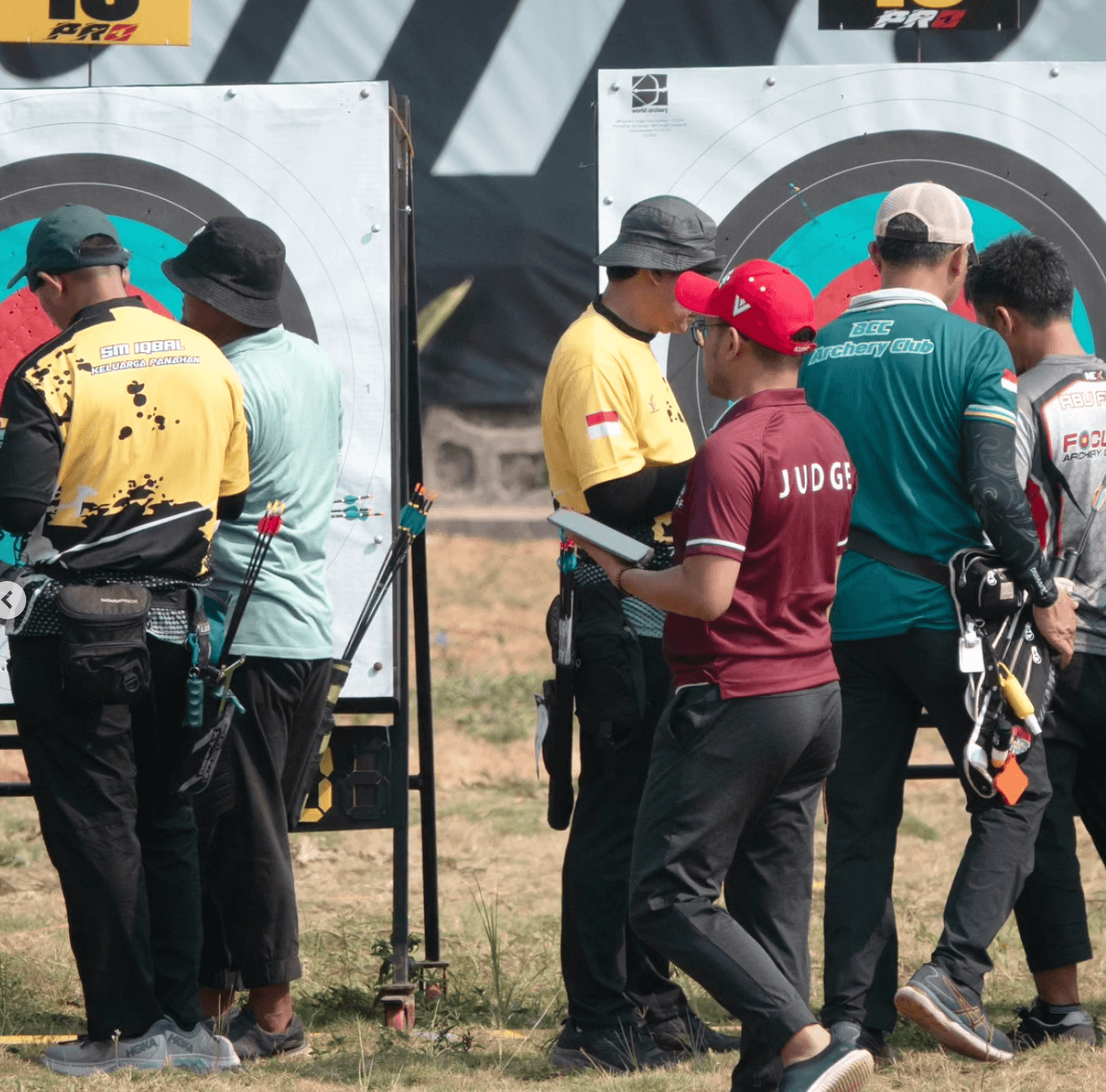 Judge at the target line validating arrows and recording results